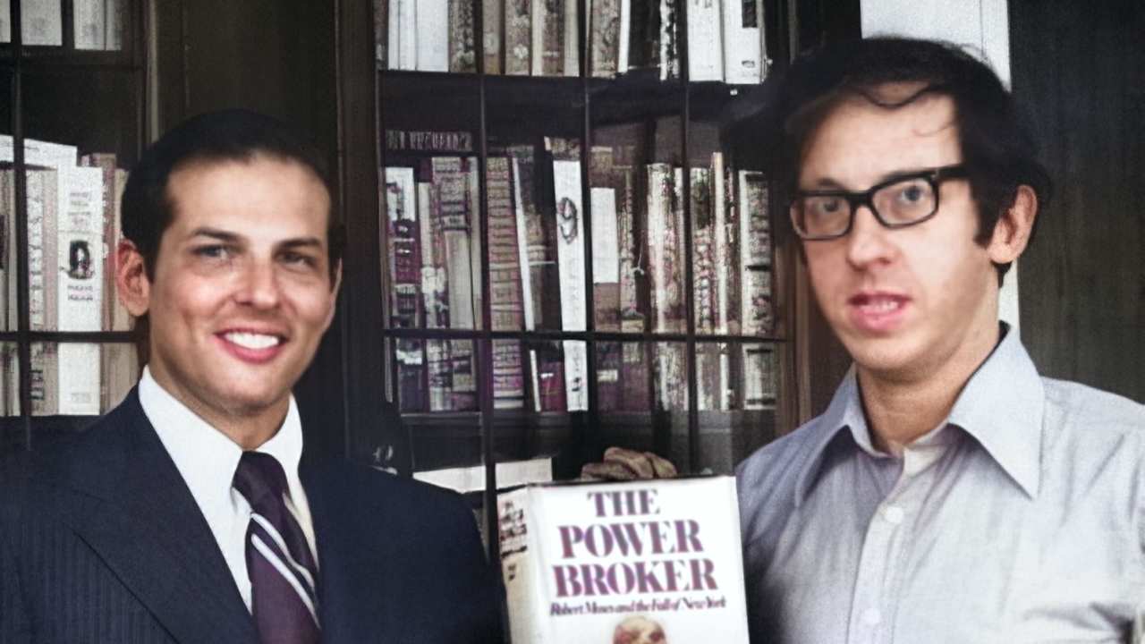 two men holding a book